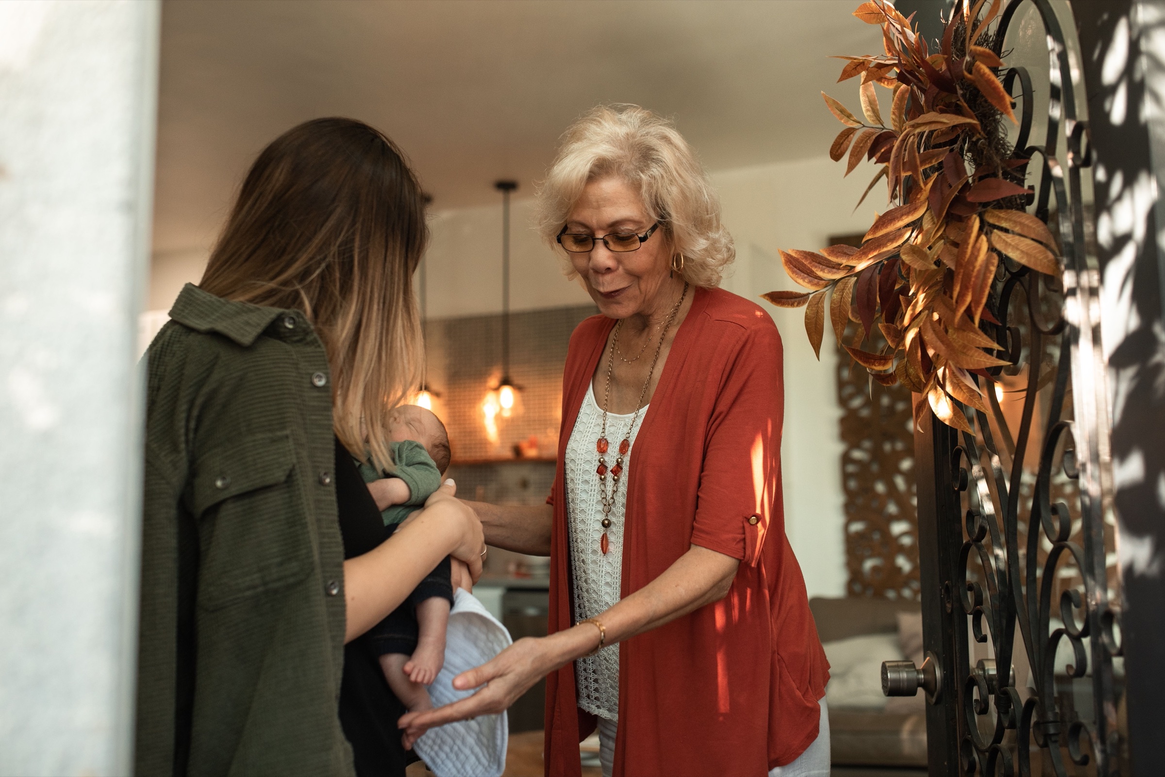 A parent greeting a caregiver at the front door